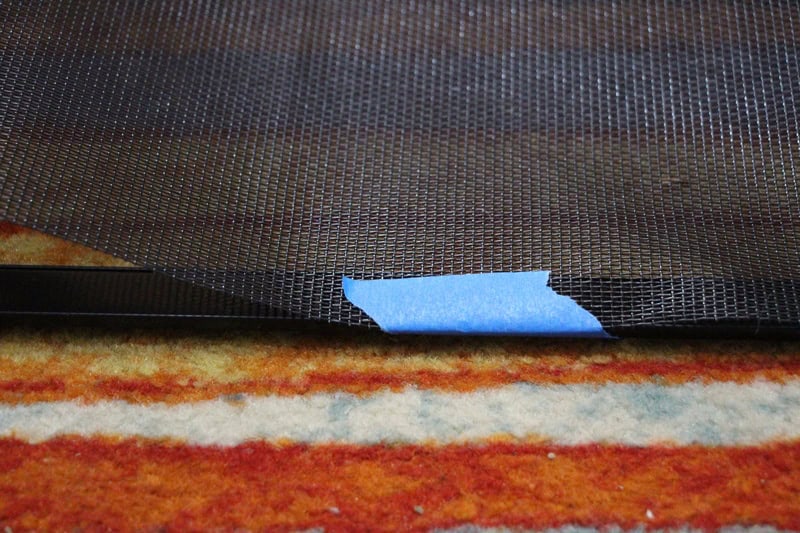 Tape holding the pet screen in place while being installed