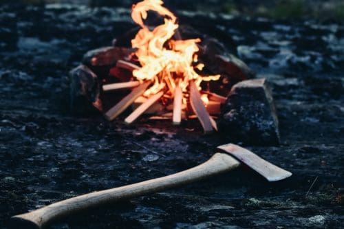 Axe in front of a campfire