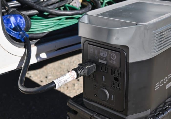 Portable power station plugged into an RV using a 30 amp to 20 amp dogbone adapter