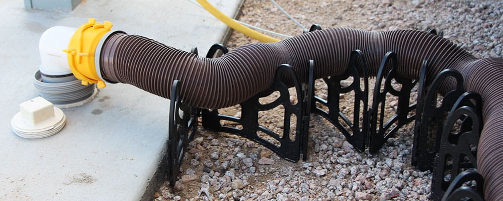 Camco Sidewinder sewer hose support holding up the end of an RV sewer hose