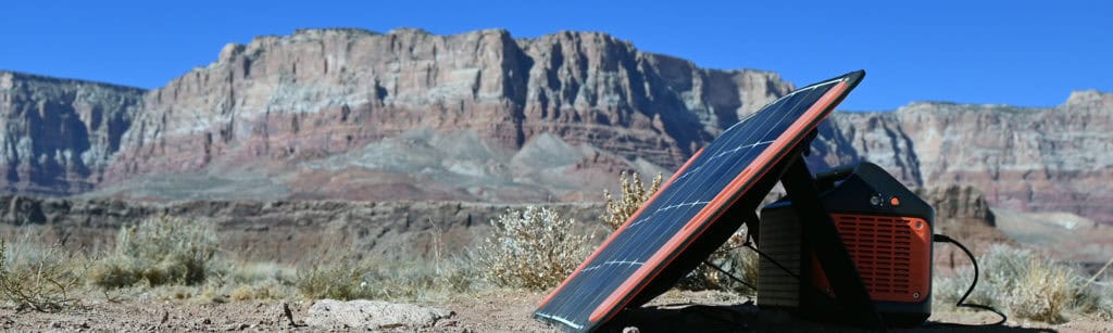 Jackery SolarSaga solar panel on the ground next to the Explorer 1000