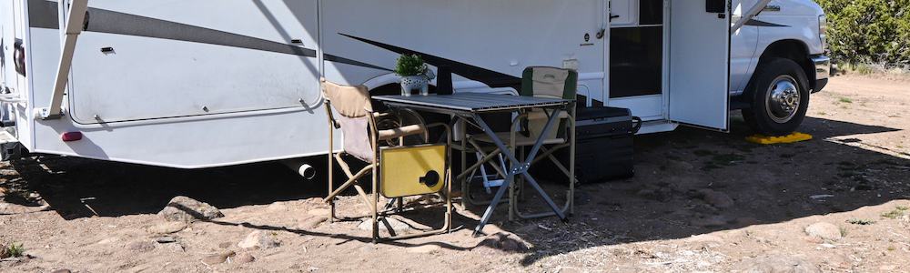 folding roll up camping table set up outside of an RV for dining