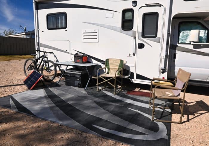 reversible plastic outdoor rug rv patio mat outside of a camper at a campground