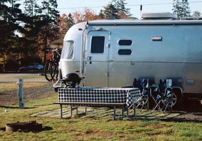travel trailer with rv bike rack on the back in a campground