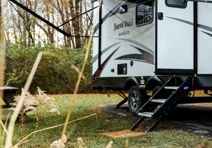 new style of rv step stair that folds out of a travel trailer or 5th-wheel and makes contact with the ground