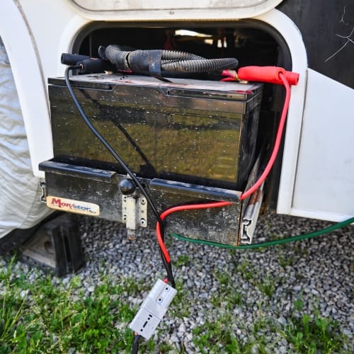 solar panel charger connected to an rv battery using alligator clips