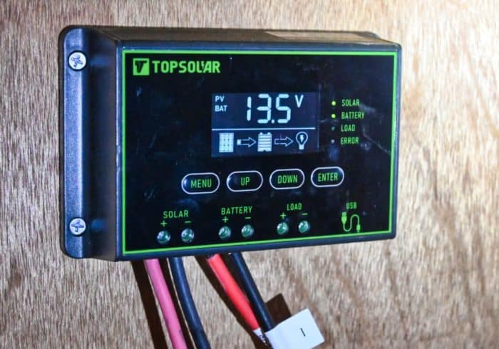 Solar charge controller connected to a solar panel charger that's charging an RV battery