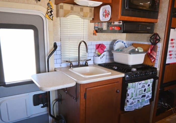 small rv kitchen filled with great kitchen accessories for full time rv living
