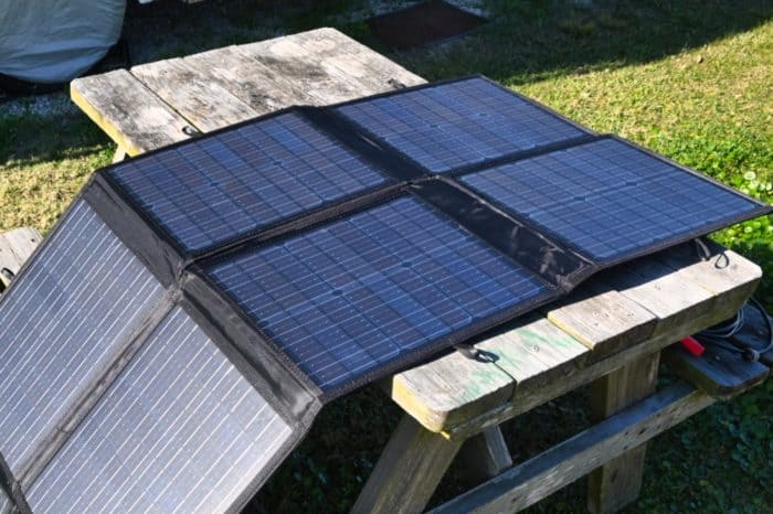 portable solar panel being used to charge an ecoflow river and jackery 500 portable power station