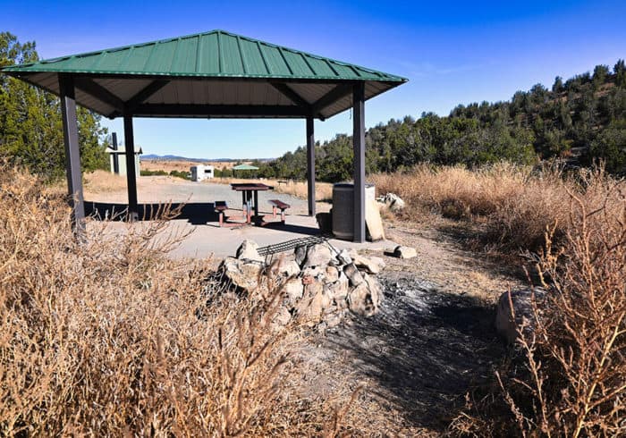 picnic table, shade structure, and fire pit at the cave canyon campground near fort stanton new mexico