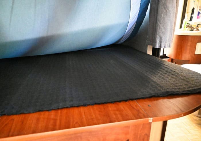 Den-Dry mattress underlay underneath a queen size mattress in an RV