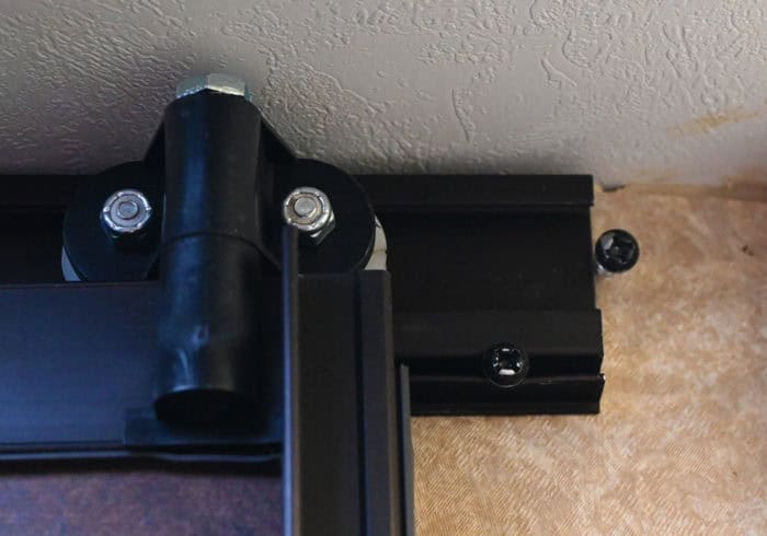 screw keeping the roller assembly from sliding out of the track on an rv sliding bathroom door