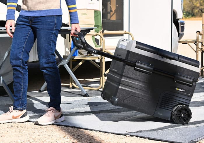 dragging the BougeRV portable fridge freezer by the extandable handle and wheels