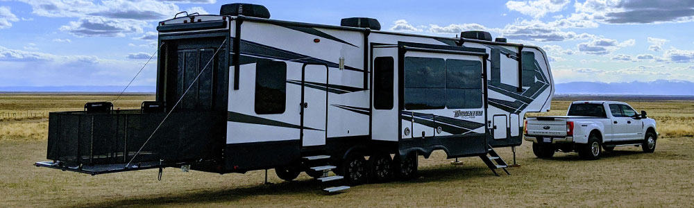 rv toy hauler with a patio kit and a ramp that is a deck