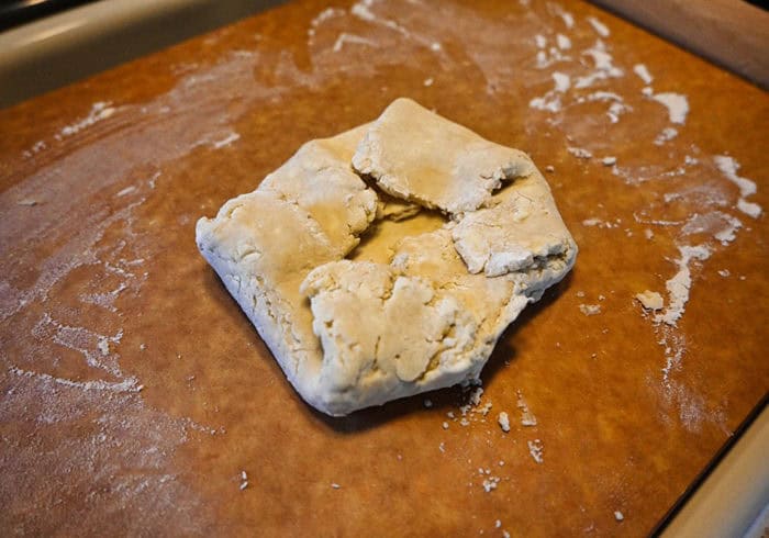 crumbly pie dough edges folded inside to be rolled out again