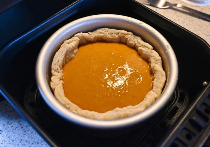 small air fryer pumpkin pie filling inside a pie crust