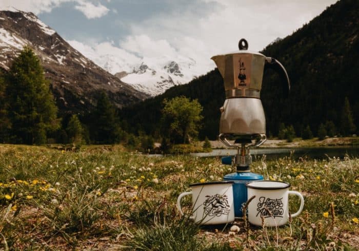 Moka coffee maker being heated with a backpacking camp stove