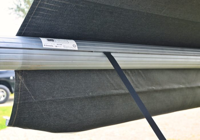 manual rv awning pull down strap mounted to the roller tube