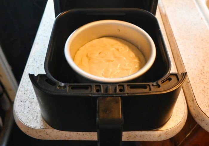 banana bread batter in small pan ready to go into the mini air fryer
