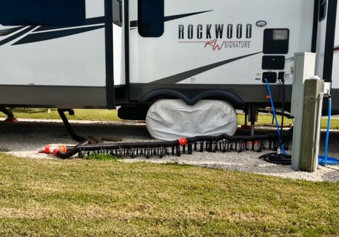travel trailer with two sewer outlets barely reaching the sewer hookup in an rv park