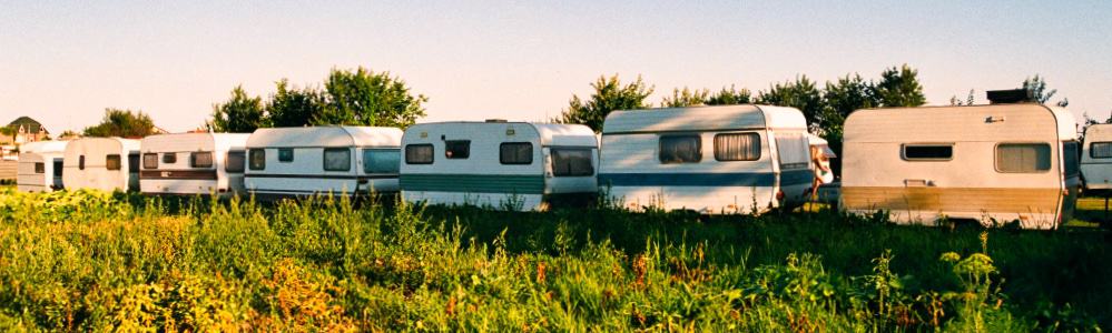 campers and travel trailes lined up with aluminum, fiberglass, EPDM, TPO rubber rv roofs