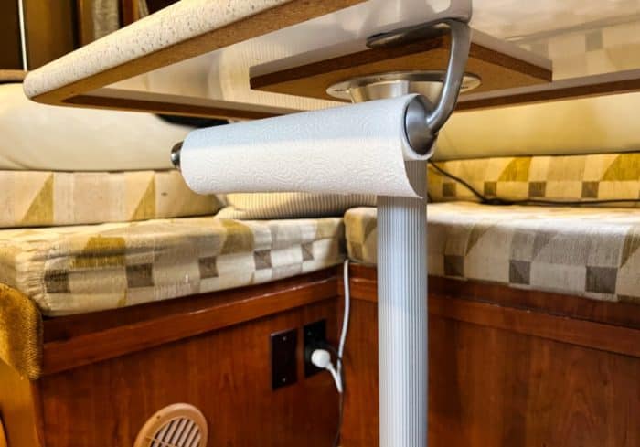 rv paper towel holder mounted under the table in a small rv kitchen