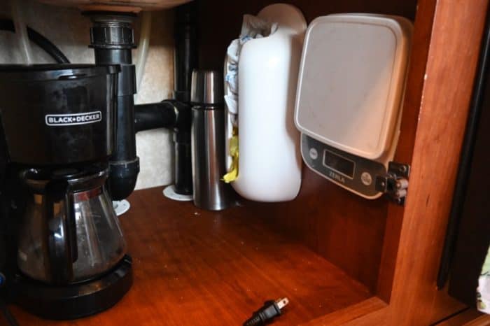 camco grocery bag holder mounted inside a small RV kitchen cabinet