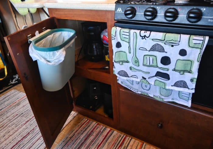 wall mount rv trash can in a small rv kitchen cabinet