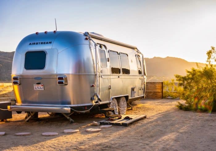airstream travel trailer rv type parked at a campsite in the mountains