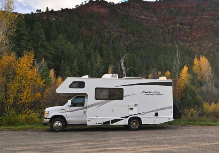 class c motorhome drivable rv type parked in mountain campground