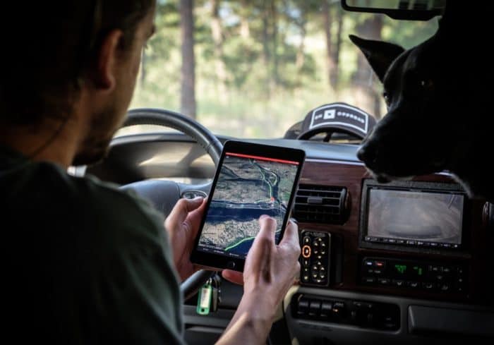 the Garmin RV GPS 890 being used in portrait mode to navigate to a forest campground
