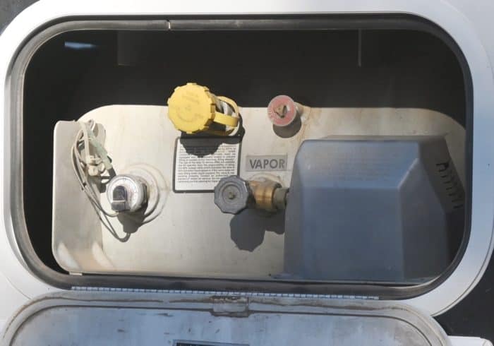 horizontal permanent propane tank on a class c rv with a horizontal propane regulator compartment