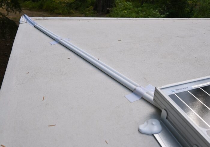 cable protectors with solar extension cables inside that are connecting a solar panel to an RV battery