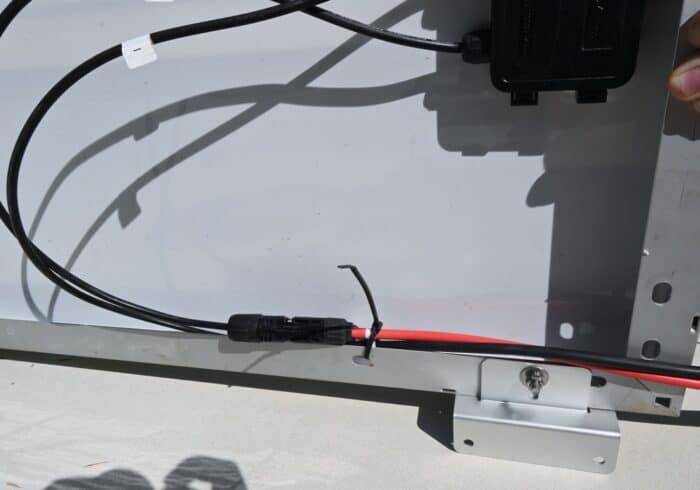 solar extension cables connected to a 100 watt solar panel on an RV roof