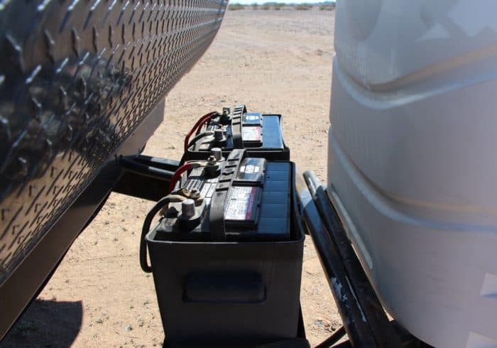 two deep cycle batteries connected in parallel to an RV and a battery charger