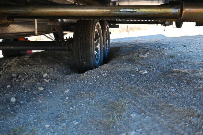hole dug under the tire of an rv trailer to change the tire without a jack or rv stabilizer jacks