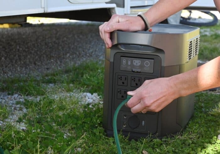 Ecoflow delta max portable power station plugged into an rv with an RV induction cooktop
