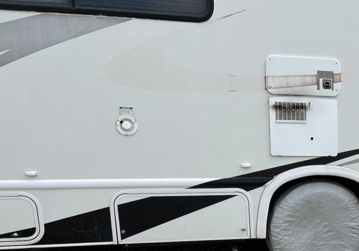 RV decals on the side of a motorhome that need to be replaced or painted over