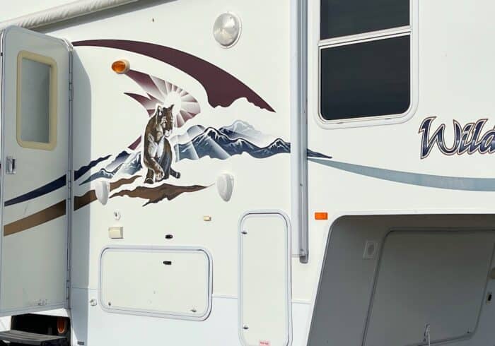 5th-wheel with RV decals that are faded, cracked, and peeling