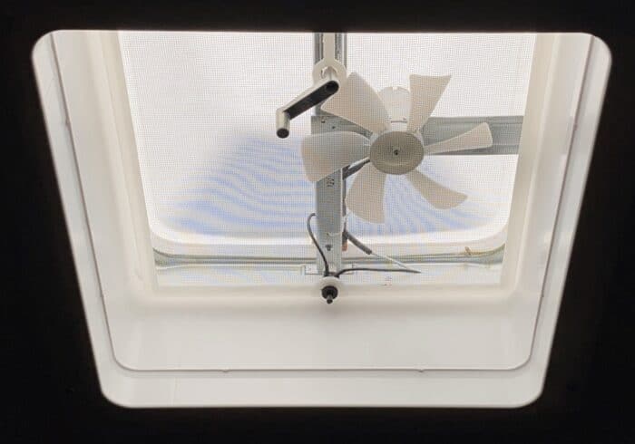simple 12 volt RV roof vent fan inside a travel trailer bathroom