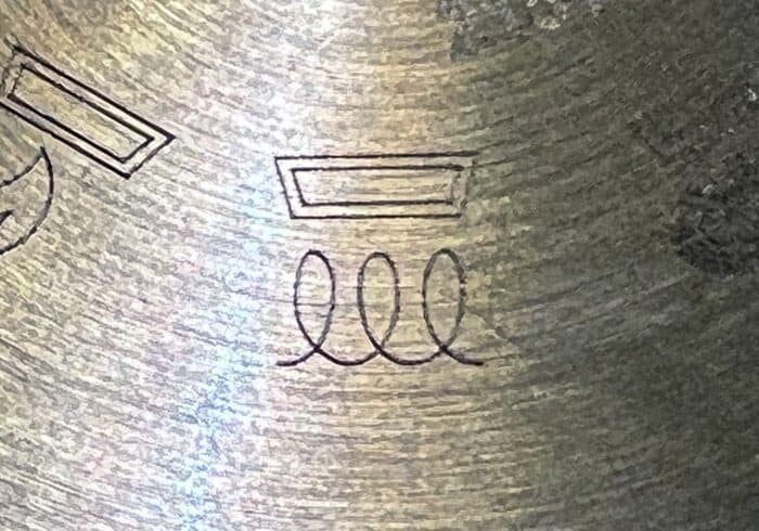induction symbol on the bottom of a stainless steel pan being used on an RV induction cooktop