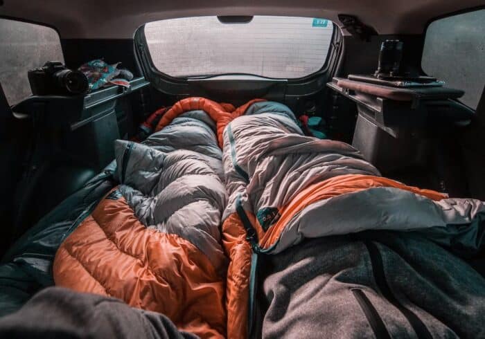 car camping with a portable heated mattress pad underneath powered by a portable power station