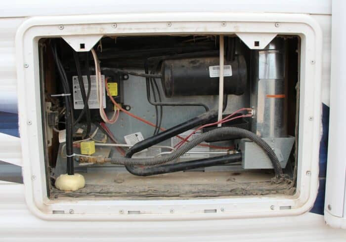 behind an rv fridge that's turned on propane during travel