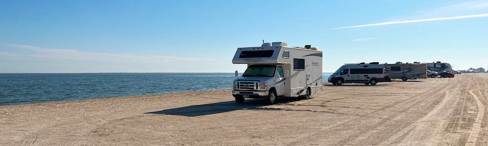 class c motorhome that's stuck in the sand and needs a heavy duty rv recovery tow strap to get unstuck