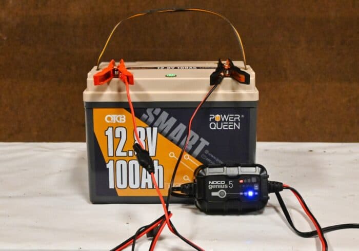 12 volt 100ah deep cycle lithium ion battery being charged by a noco genius 5 battery charger