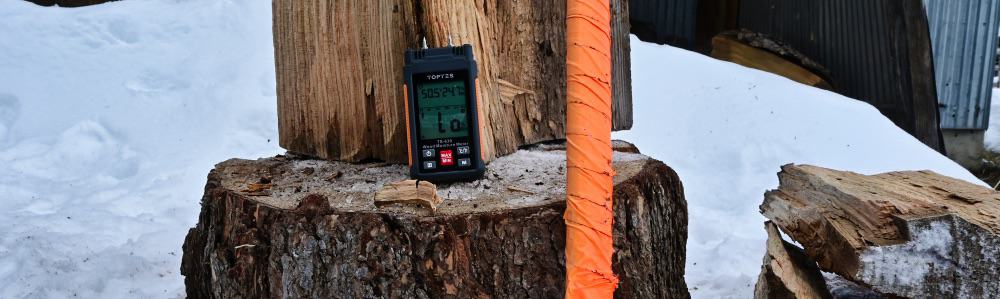 ts-630 toptes moisture meter being used to find dry firewood for a campfire