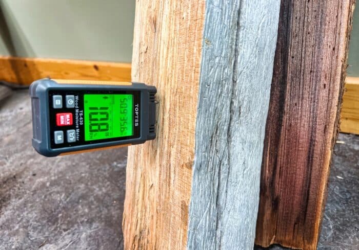green backlight on the ts-630 toptes moisture meter in a pine log