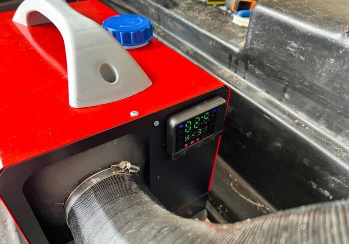 lcd screen on the vevor portable diesel heater installed in the storage compartment of an rv