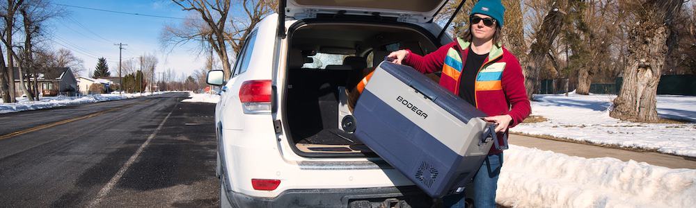 taking the bodega t50 portable car refrigerator out of the trunk of an suv