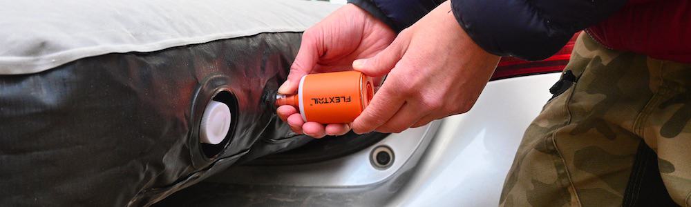 Flextail Tiny Pump 2X mini portable electric air pump being used to inflate a camping air mattress